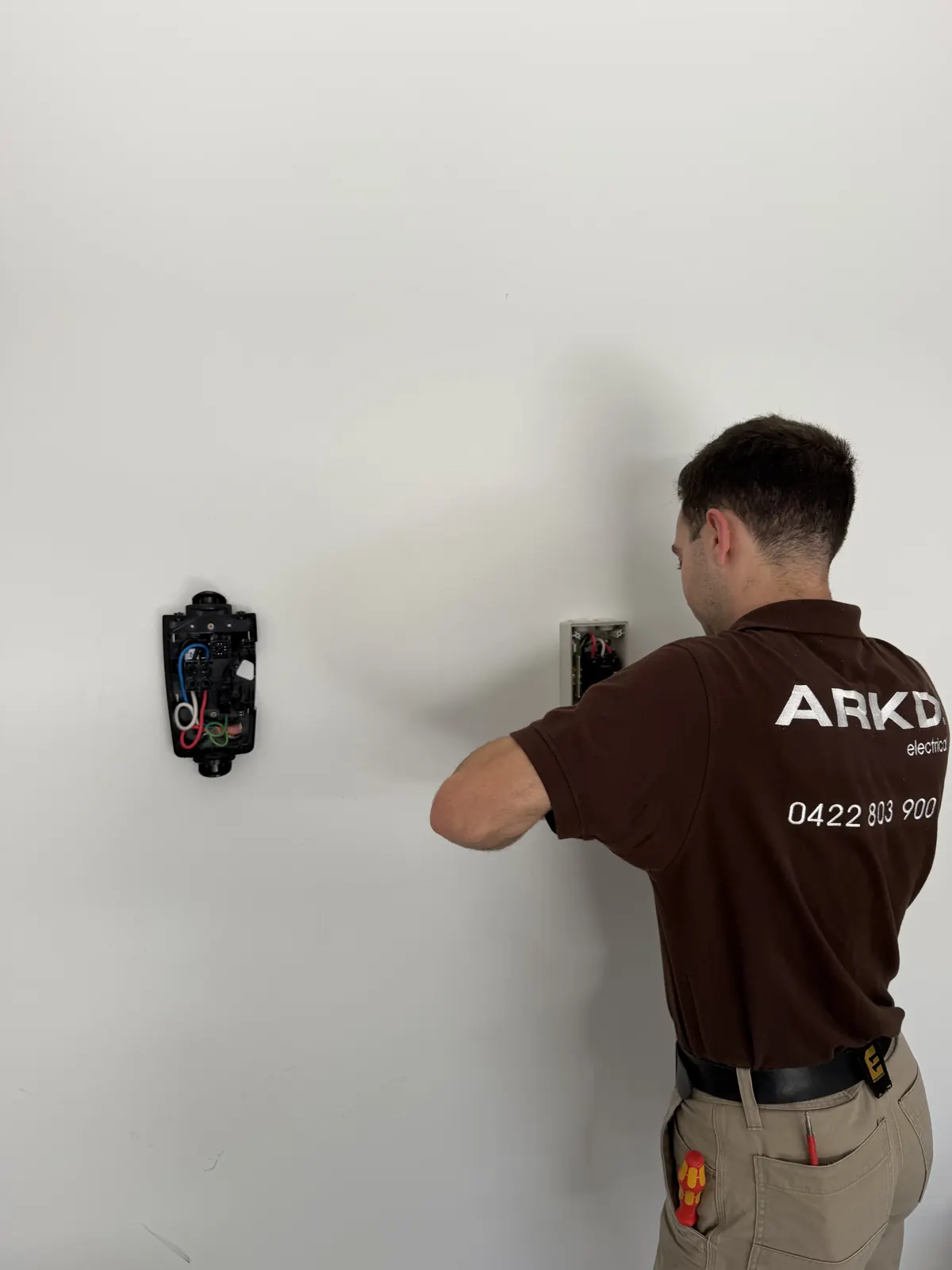 ARKD electrician installing a safety switch on a Brisbane property