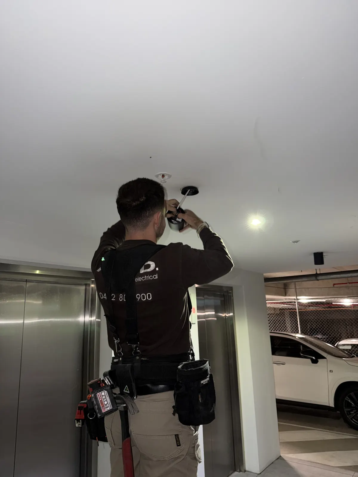 ARKD commercial electrician servicing carpark lighting in a Brisbane building