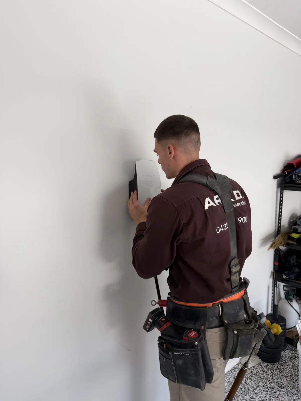 ARKD electrician installing a Tesla Wall Connector EV charger in Brisbane