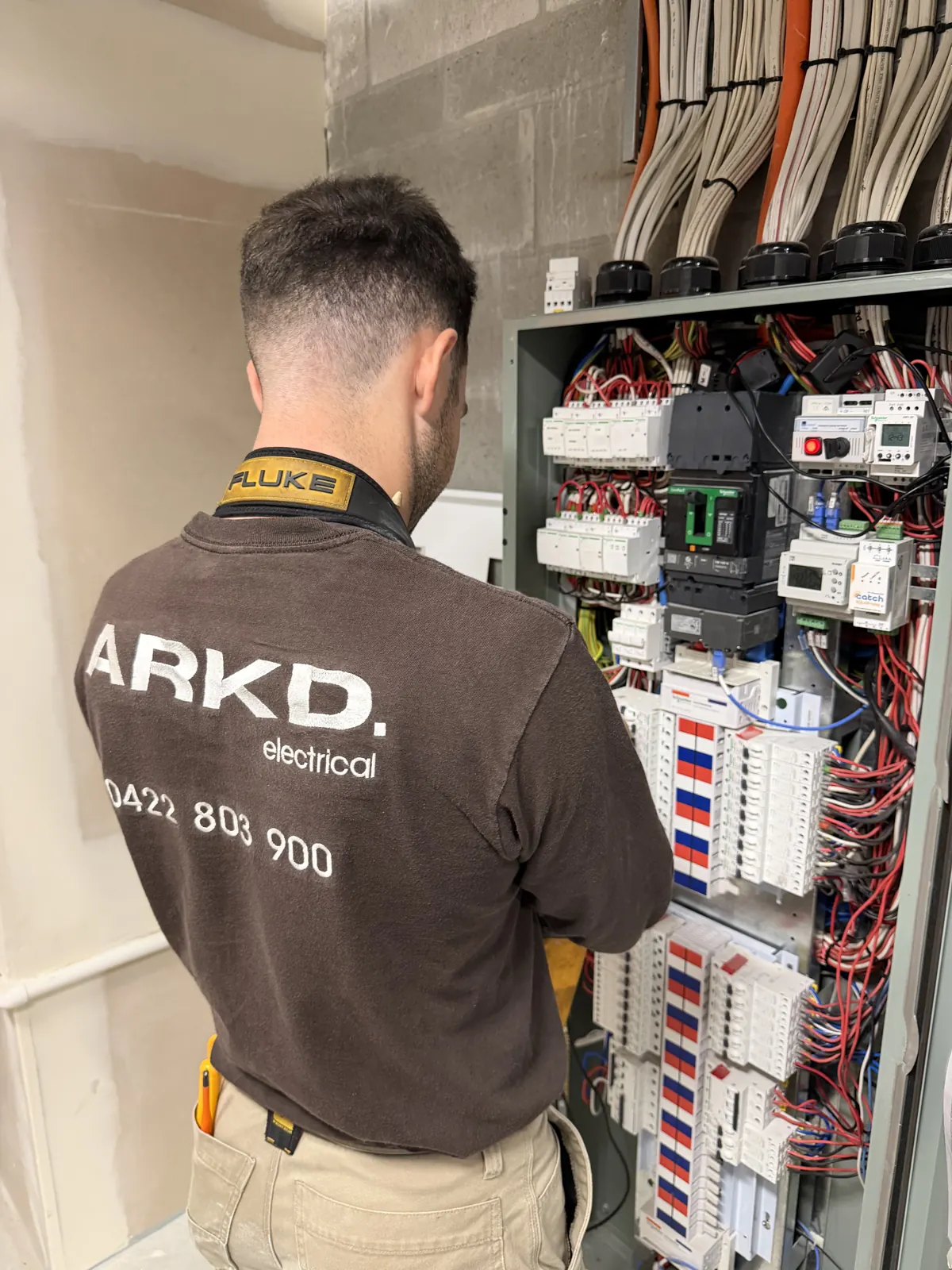 ARKD electrician working on a commercial switchboard in Brisbane