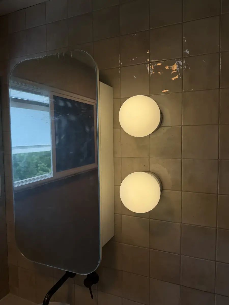 Feature wall lighting in a renovated Brisbane bathroom